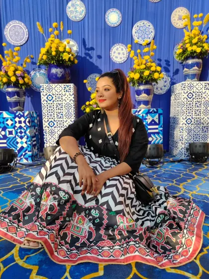 "In the lap of Tradition, I find my Style." Seated amidst beautiful blue and white decor, my black and white lehenga with traditional motifs is a perfect blend of modern design and cultural roots.