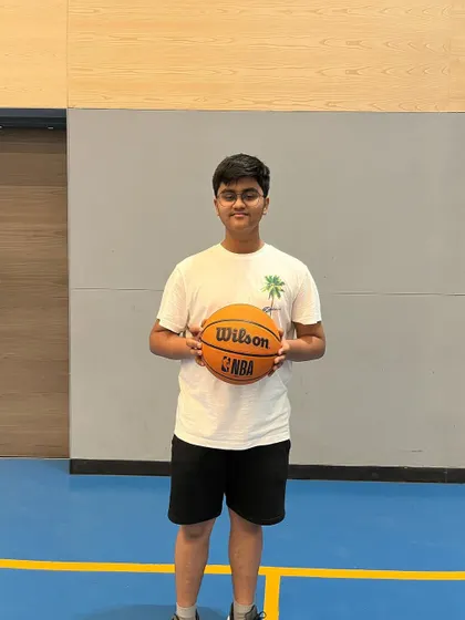 A happy participant from our summer basketball camp. Our camps are all about improving skills and having fun.