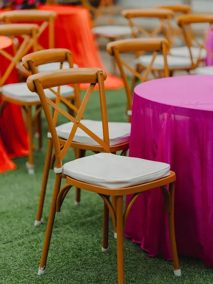 The guest seating features tables with vibrant pink and orange linens and classic cross-back chairs, perfectly matching the Moroccan theme.