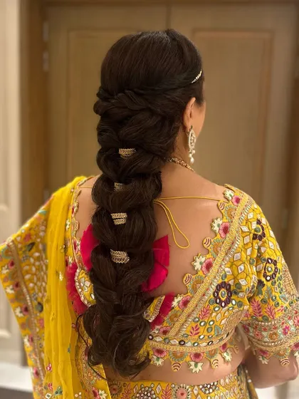 A classic, thick pull-through braid for the groom's mom. This elegant and traditional style gets its impressive volume from my extensions, perfect for a royal look.
