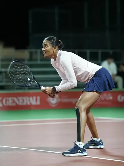 An intense focus from our player as she prepares to receive a serve during a crucial phase of the match.