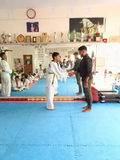 A student receives his new belt.