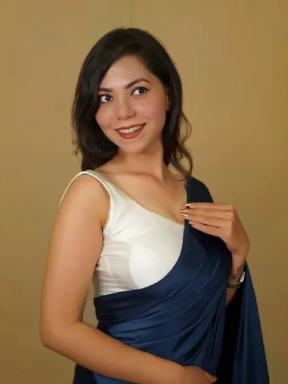 A classic white sleeveless blouse, perfect for pairing with satin or chiffon sarees for a clean, modern look.