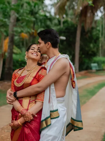 A moment of pure joy and affection. This candid-style portrait captures the groom's loving embrace and the bride's blissful smile, telling a story of happiness.