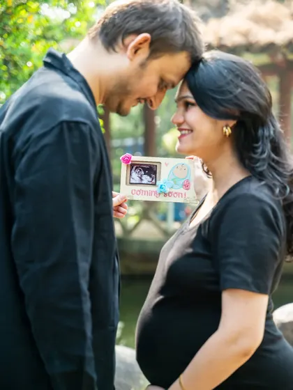 Holding up a sonogram picture is a beautiful way to include the baby in the maternity shoot. This close-up shot focuses on the couple's happy expressions as they look at their little one's first photo.