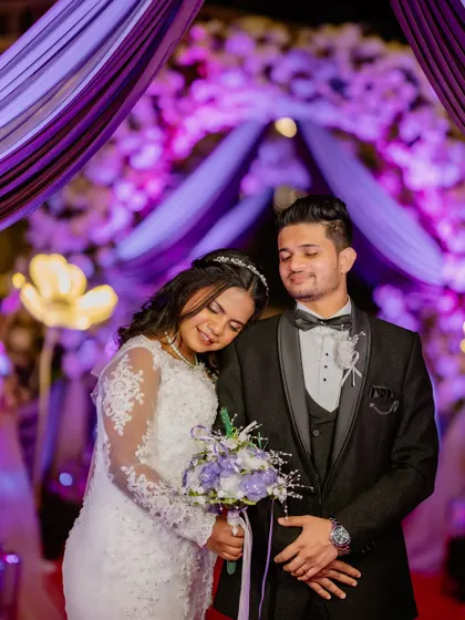 A sweet moment during the reception. Eliza's soft makeup look, featuring a warm lip color, looks stunning against the colorful decor.