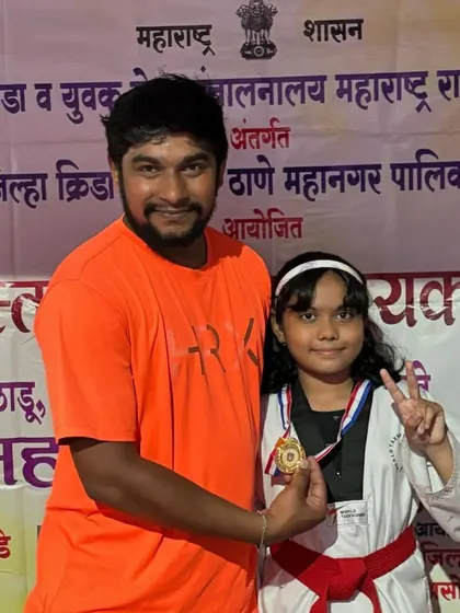 Celebrating a victory with my student Riddisha Gaunsdesai after she won a gold medal at the DSO competition. She is giving the victory sign, full of confidence.