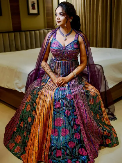 Purple, playful, and picture-perfect for Shloka's sangeet. This look combined soft sparkle with bold, colorful hues to match her vibrant personality and the joyous celebration.