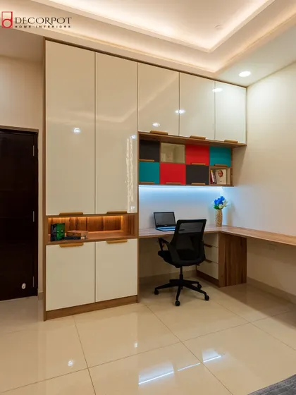 A full view of the integrated study unit from image 26. The combination of glossy white cabinets, wood finishes, and colorful niches creates a workspace that is both organized and inspiring.