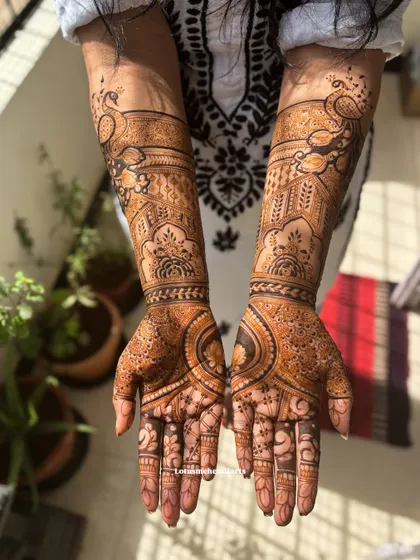 This gorgeous bridal design is centered around the majestic peacock, a symbol of grace and beauty. The detailed feather work and surrounding patterns make it a true showstopper.