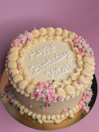 A classic birthday cake with delicate pink floral piping. This design shows our skill with traditional buttercream work, perfect for creating a beautiful and timeless celebration cake.