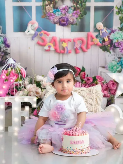 A beautiful first birthday setup with a personalized milestone board. This is a wonderful way to remember all the little things that made their first year so special.