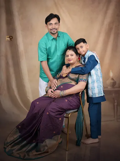 A beautiful family portrait celebrating tradition. The whole family is dressed in ethnic wear, creating a memory that honors your heritage as you welcome a new member.