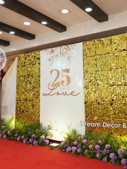 A grand celebration for a 25th anniversary. The stage features a gold sequin wall, a personalized '25 Years of Love' sign, and large light-up marquee numbers.
