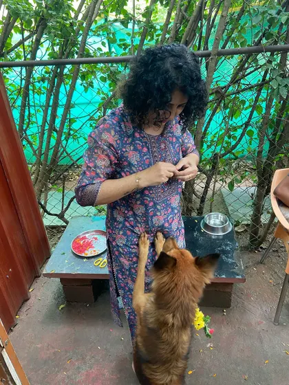 A dog eagerly reaches up for a treat after the puja. Celebrating together is a key part of our home-like atmosphere.