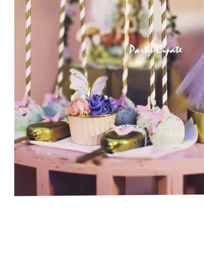 A close-up of the butterfly-themed desserts. We had custom cupcakes with delicate butterfly toppers and matching cakesicles, all displayed on a themed table.