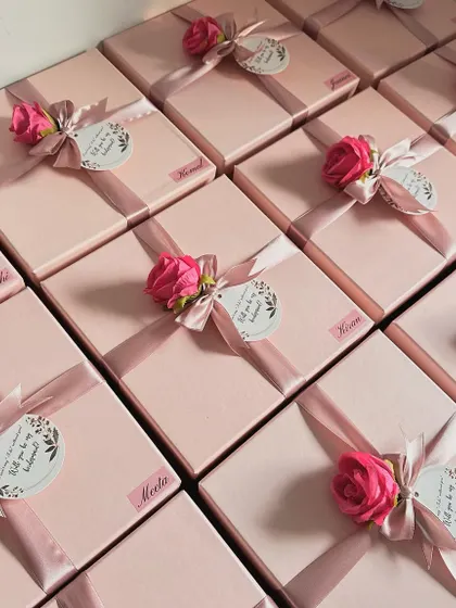 A full view of the personalized bridesmaid boxes, each with a name sticker, a beautiful ribbon, an artificial rose, and a proposal tag. They look so stunning all together!