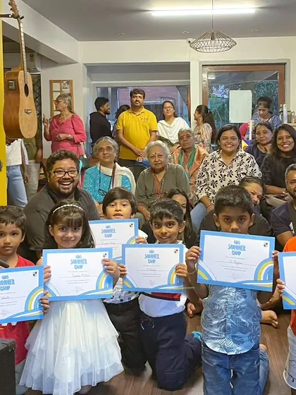 The graduating class of our Summer Camp, proudly holding their certificates with their parents and teachers.