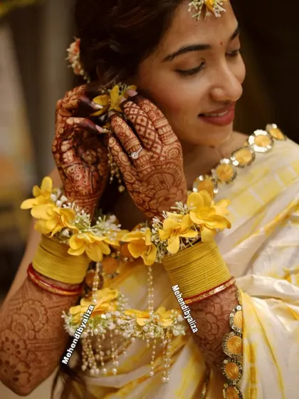 Another beautiful shot of the bride during her haldi ceremony, showing how the henna becomes a part of the entire bridal look.