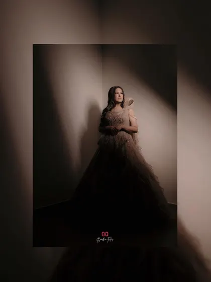 An artistic and moody portrait of the bride in her engagement gown, using dramatic shadows to create a sense of mystery and elegance.