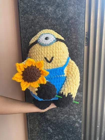 A custom order for a very soft and squishy Minion, holding a single crocheted sunflower. I used a plush, thick yarn for this to make it extra huggable.