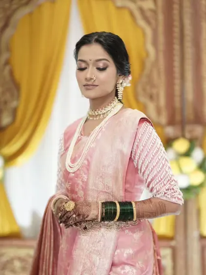 A side view of the beautiful Maharashtrian bride, her mehandi adding to her elegance.