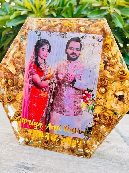 An 8-inch hexagon block filled with preserved golden-yellow roses. The couple's photo and names are set against a backdrop of their wedding flowers.