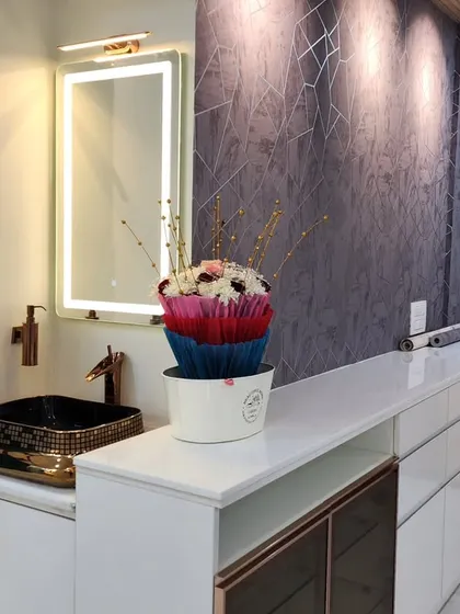 This image shows a custom-designed wash basin and counter unit integrated into the living area, complete with a backlit mirror and stylish fixtures.
