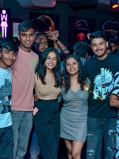 A large group of friends smiling and enjoying the party together. I love seeing people connect and have fun at my events.