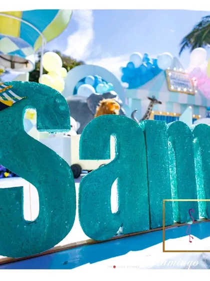 A large, glittering 'SAM' sign was created for one of the birthday twins, personalizing the carnival space.
