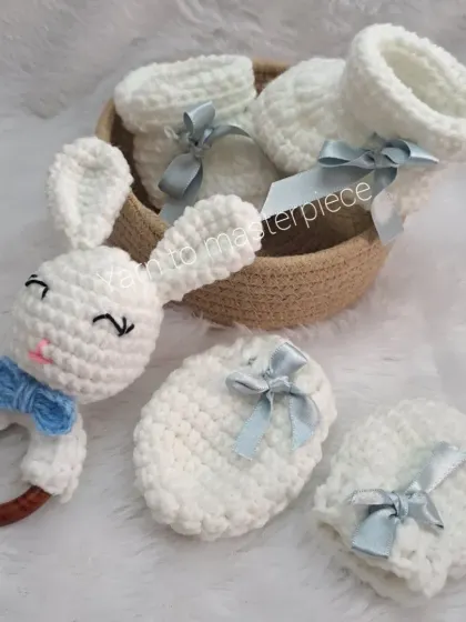 The full baby boy gift set, including the bunny rattle with a blue bow tie, matching mittens, and booties.