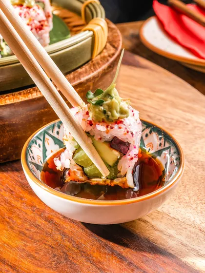 Savor the intricate craftsmanship in every bite. Our sushi roll is a delicate harmony of fresh ingredients and rich flavors, showcasing true culinary artistry.