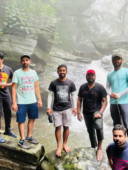 Friends posing by a stream on the Bandaje trek. The trail offers many beautiful spots for photos.