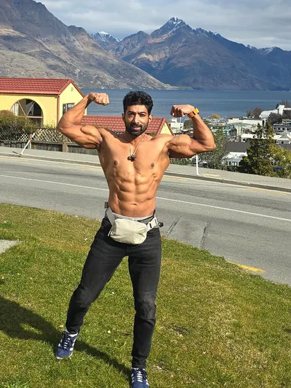 A front double biceps pose in New Zealand. Fitness is a lifestyle you take with you wherever you go.