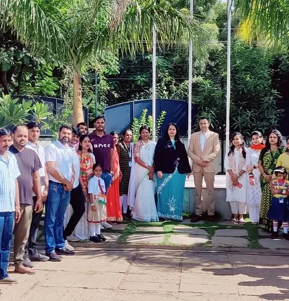 Parents, teachers, and students gather around the flagpole, united in celebrating India's independence.