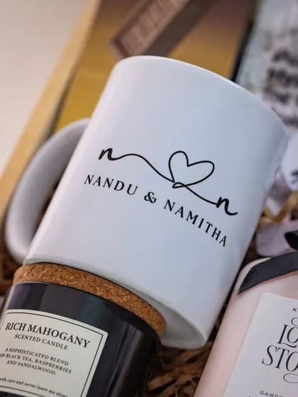 A personalized mug for the couple 'Nandu & Namitha', featuring their names connected by a heart. This is a sweet, custom touch for a newlywed gift.