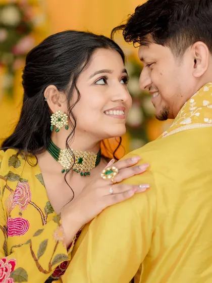 A close-up portrait from Shivangi and Aakash's Haldi, capturing the loving gaze they share.