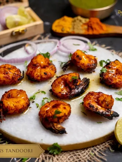 Our Prawns Tandoori, marinated in rich spices, promises a celebration of flavor in every bite.