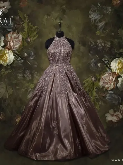 Make a grand entrance with this halter neck brown gown, a true showstopper with its beautiful volume and embellishments.