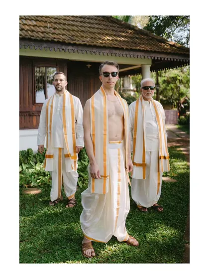 The groom and his groomsmen, all dressed in traditional Indian attire. This portrait captures their camaraderie and style against a rustic, natural backdrop.