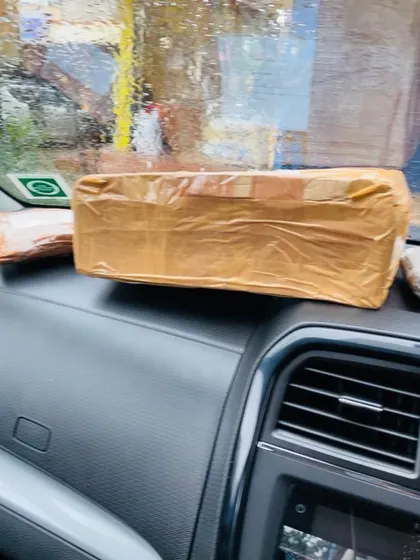 A securely taped package on the dashboard, about to be dropped off for courier. I personally oversee the dispatch of my products to ensure they reach you safely.
