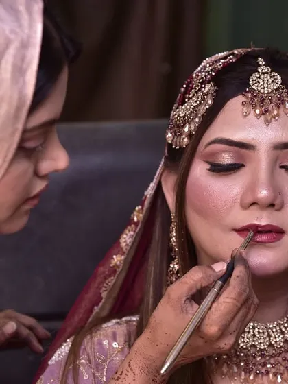 The final touch. Applying lipstick with a brush ensures a precise and long-lasting application for my engagement bride.