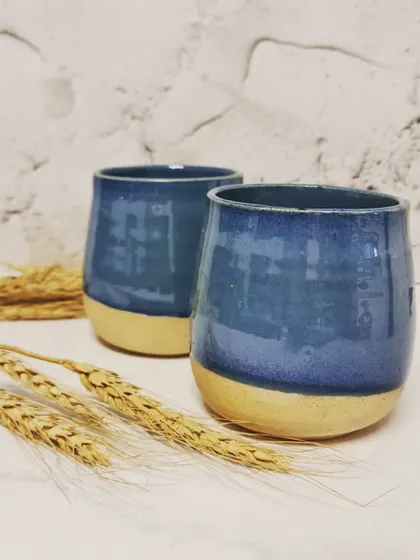 A pair of my blue ceramic tumblers. These can be safely used in dishwashers and microwaves, but I always recommend handling them with care to ensure they last.