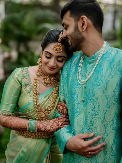 A tender moment between the couple, showcasing their beautiful coordinated outfits. Our goal is to capture the subtle emotions and details that make your wedding portraits special.