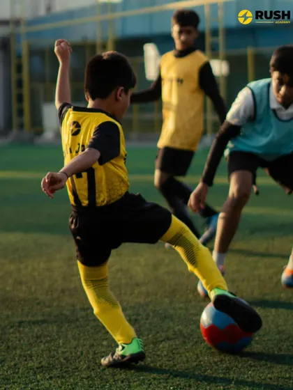 A young athlete in our U11 program executes a powerful kick during a practice game. This action shot captures the determination and skill we nurture in our players.