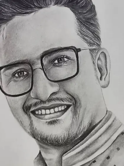 A close-up of the man's face from a couple portrait, showing the detail in his glasses and the texture of his kurta.