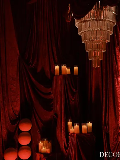 Another view of the decor elements, showing how we use varying heights to create visual interest. The candles are placed on draped pedestals to enhance the dramatic effect.