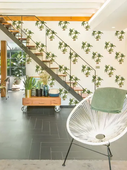 This modern living space is softened with the playful addition of our Group of Palm Trees wall stickers. They add a touch of nature and whimsy to the clean lines of the room.