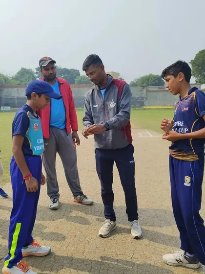 A coach explaining the field setting to the captains. Tactical awareness is a crucial part of the game we teach.