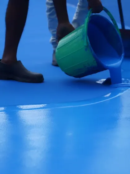 A close-up of the vibrant blue acrylic being poured and spread. This is where the groundwork for future aces is laid, showcasing our investment in quality from the ground up.